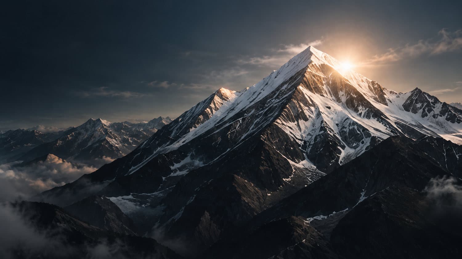 Snow-capped mountain peak catching the sun above the clouds